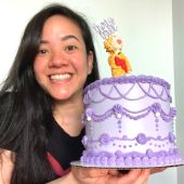 Julie holding a beutiful purple birthday cake